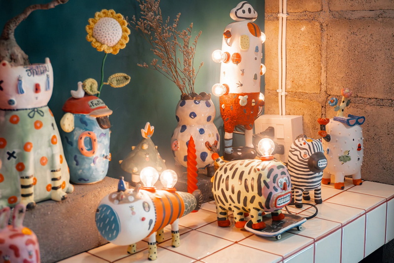 Colorful Animal Figurine Collection at Baan Kang Wat Collection of colorful animal-themed ceramic figurines with lights on a tiled surface at Baan Kang Wat.