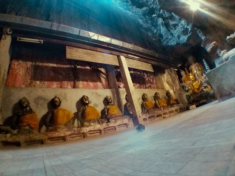 Monk Statues Inside the Cave at Chiang Dao Cave Inside a cave with monk statues and a painted ceiling, some wearing gold robes at Chiang Dao Cave.