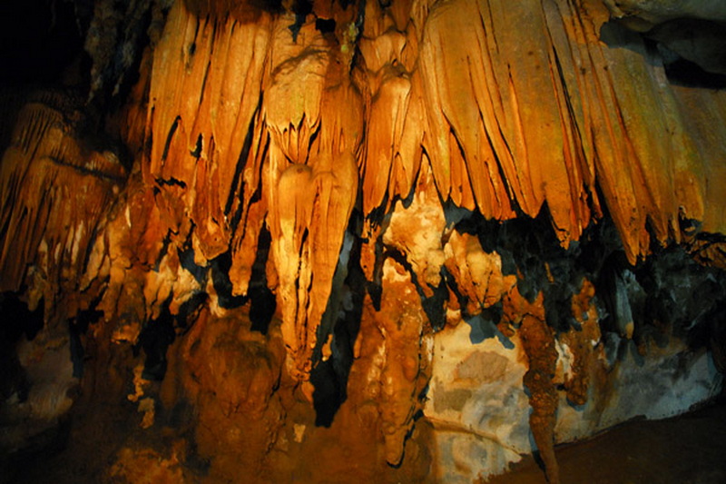 Cave Interior with Stalactites at Chiang Dao Cave Inside a cave with orange stalactites hanging from the ceiling and rock formations on the walls at Chiang Dao Cave.
