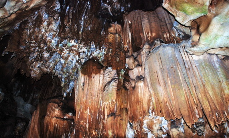 Close-up of stalactites and stalagmites inside a limestone cave with mineral textures at Chiang Dao Cave.