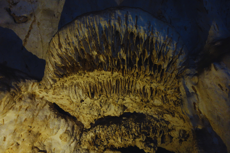 Close-up of stalactites hanging inside a limestone cave with detailed formations at Muang On Cave.