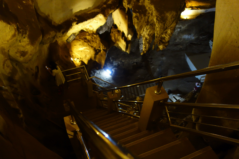 Inside Muang On Cave Staircase inside Muang On Cave with rocky walls and metal handrails