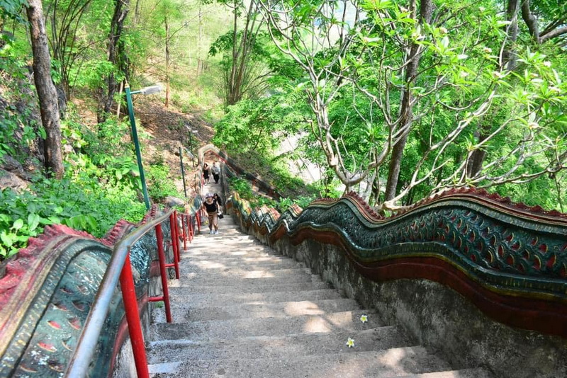 Lush Staircase with Decorative Railings at Mueang On Cave Stone staircase with decorative railings amid vibrant green trees and foliage at Mueang On Cave.