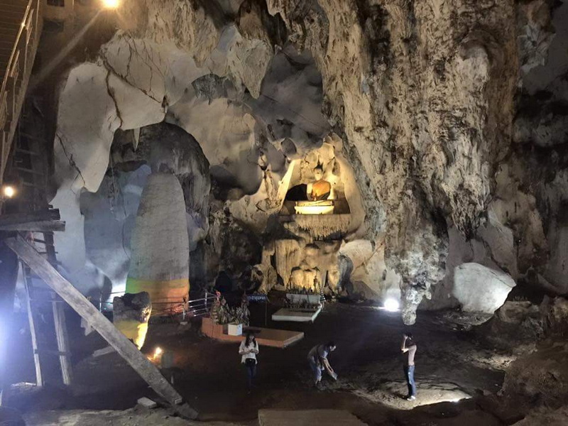 Inside Muang On Cave Visitors inside Muang On Cave viewing stalactites and stalagmites formations illuminated by lights