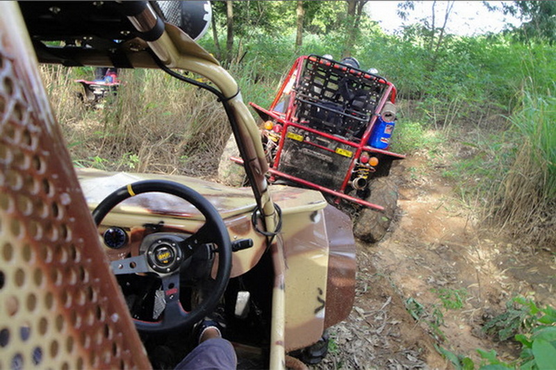View from inside an ATV riding through a forested dirt trail at Chiang Mai atv tour.