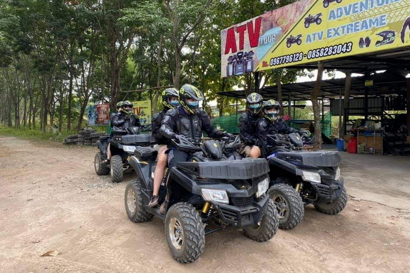 ATV Tour Group in Chiang Mai at ATV tour Chiang Mai Group of people in helmets on ATV vehicles at a tour site at ATV tour Chiang Mai.