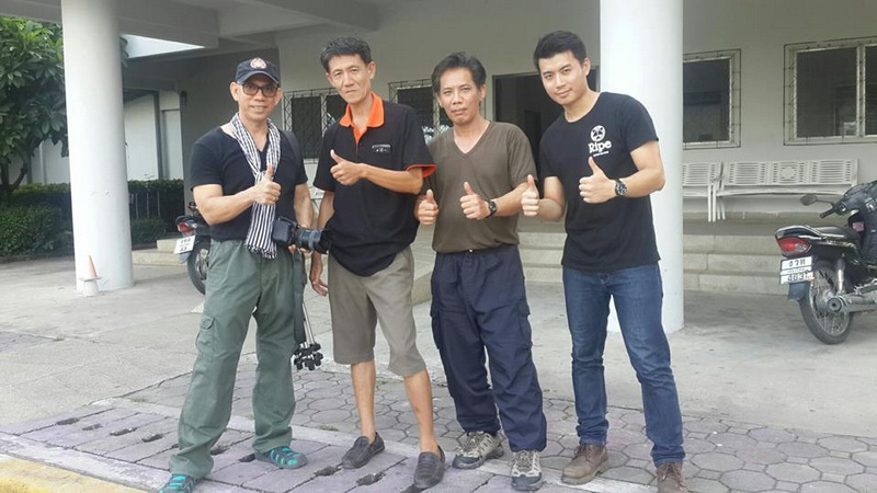 Four individuals standing outside a building giving thumbs up sign at Chiang Mai Shooting Club.