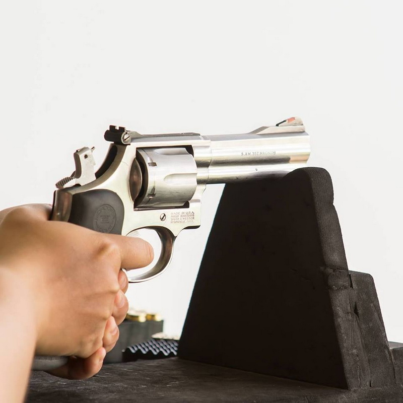 Revolver Shooting Practice at Chiang Mai Shooting Club Person holding a silver revolver pointed at a black target stand at Chiang Mai Shooting Club.