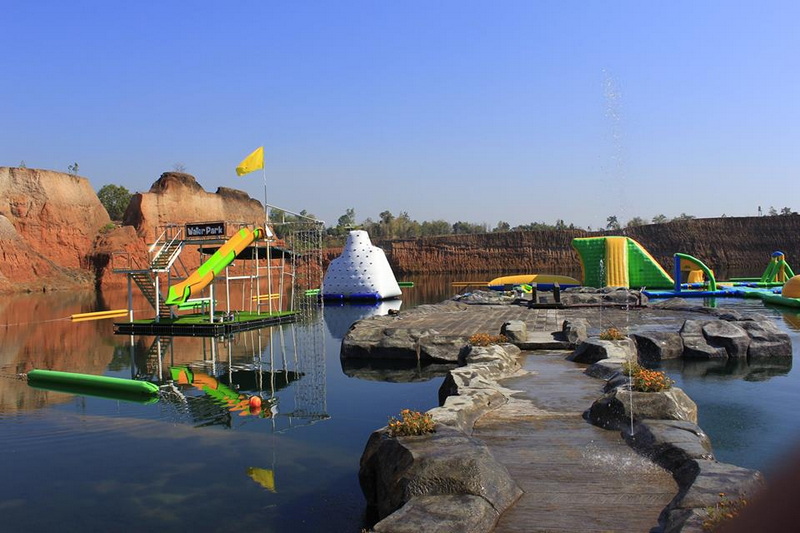 Inflatable Water Playground at Grand Canyon Chiang Mai Colorful inflatable water playground with slides on a calm body of water at Grand Canyon Chiang Mai.