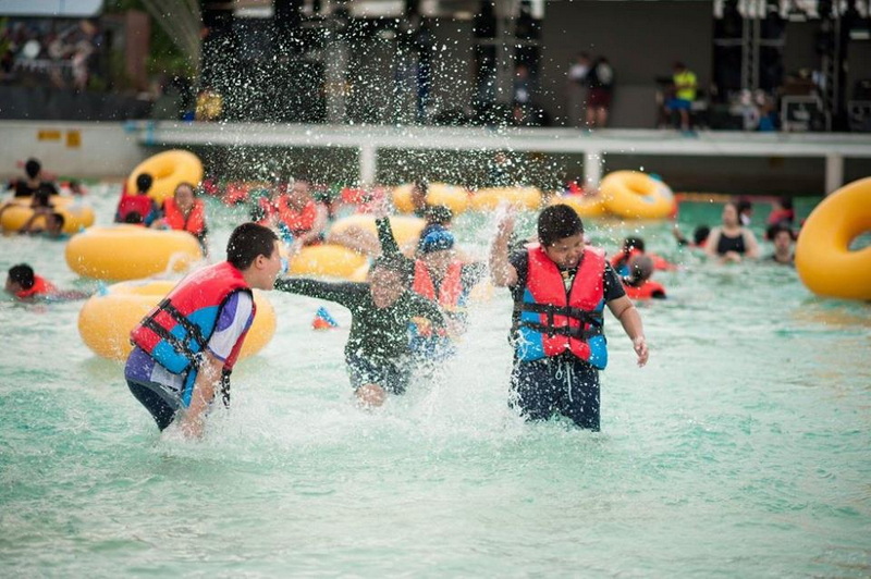 Children enjoying water play with inflatable rings in a water park at Tube Trek Water Park.