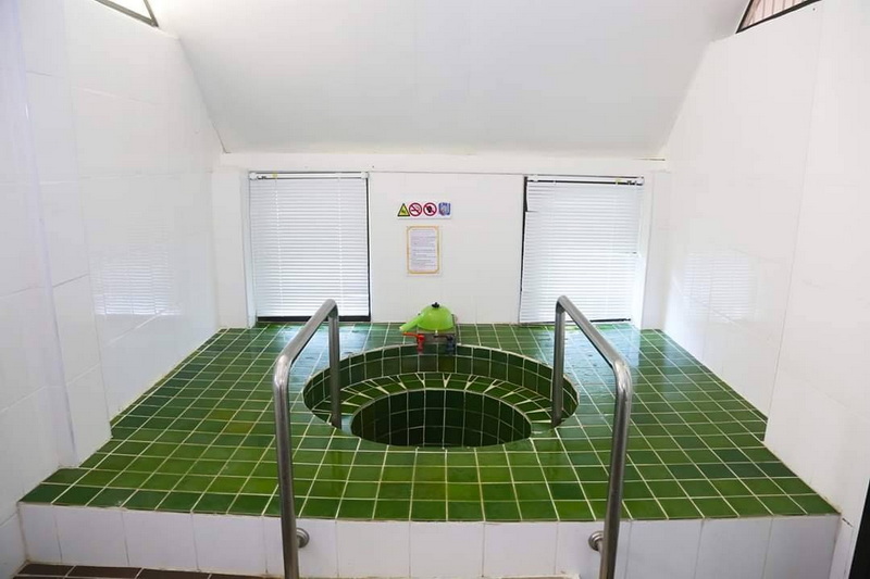 Indoor Pool with Green Tiles at San Kamphaeng Hot Springs Indoor swimming pool with green tiles, metal handrails, and small windows with blinds at San Kamphaeng Hot Springs.