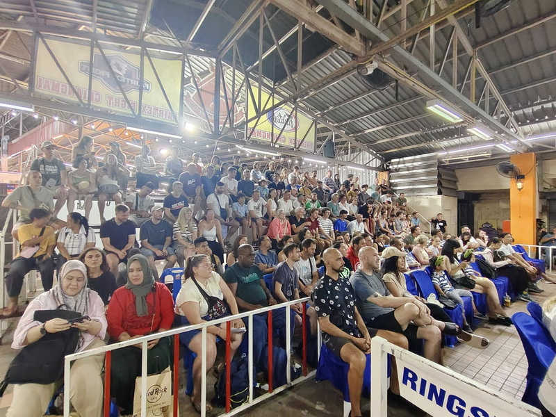 Indoor Stadium Audience at Kalare Boxing Stadium Crowd of spectators sitting in a stadium with tiered seating and metal roof structure at Kalare Boxing Stadium.