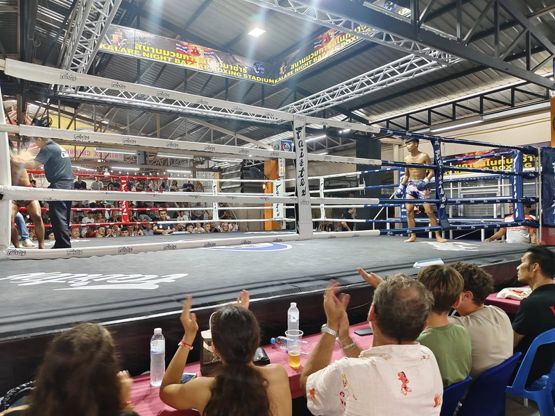 Indoor boxing match with fighters and audience in a stadium at Kalare Boxing Stadium.