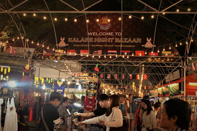 Chiang Mai Night Bazaar Scene Vibrant night market with stalls, shoppers, and decorative lights at Chiang Mai Night Bazaar