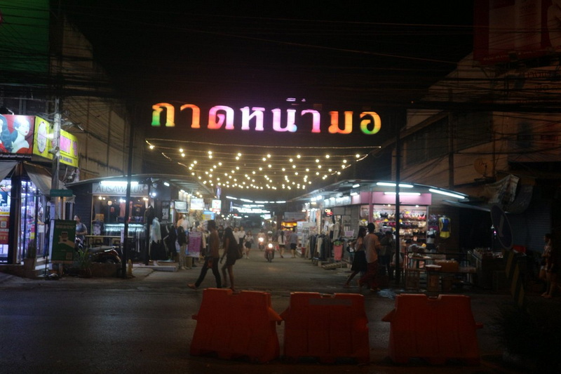 Night Market Scene at Chiang Mai Night Market Shopping Night market with illuminated sign and bustling street stalls at night at Chiang Mai Night Market Shopping.