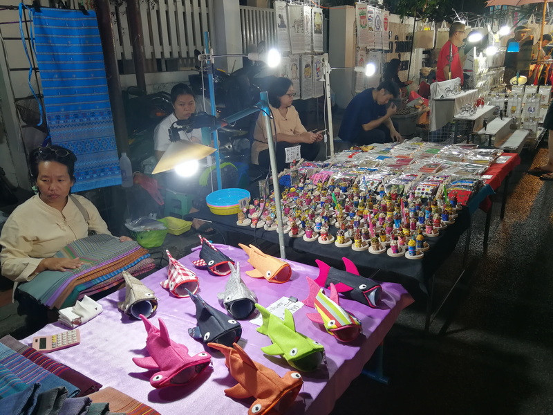 Night Market Toy Stalls at Saturday Walking Street Chiang Mai Market stall displaying colorful handmade plush toys and figurines at night at Saturday Walking Street Chiang Mai.