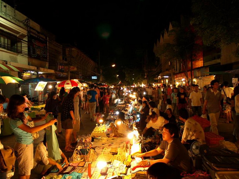 Night Market Bustle in Chiang Mai at Sunday Night Market Chiang Mai Night scene of a bustling street market with busy stalls and shoppers at night at Sunday Night Market Chiang Mai.