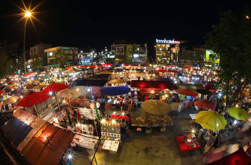 Night Market Scene at Sunday Night Market Chiang Mai Vibrant night market with colorful stalls and umbrellas illuminated after dark at Sunday Night Market Chiang Mai.