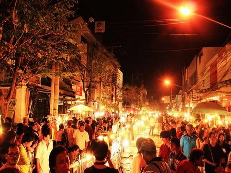 Night Market Crowd at Sunday Market Chiang Mai Vibrant night market street bustling with shoppers and bright stalls at night at Sunday Market Chiang Mai.
