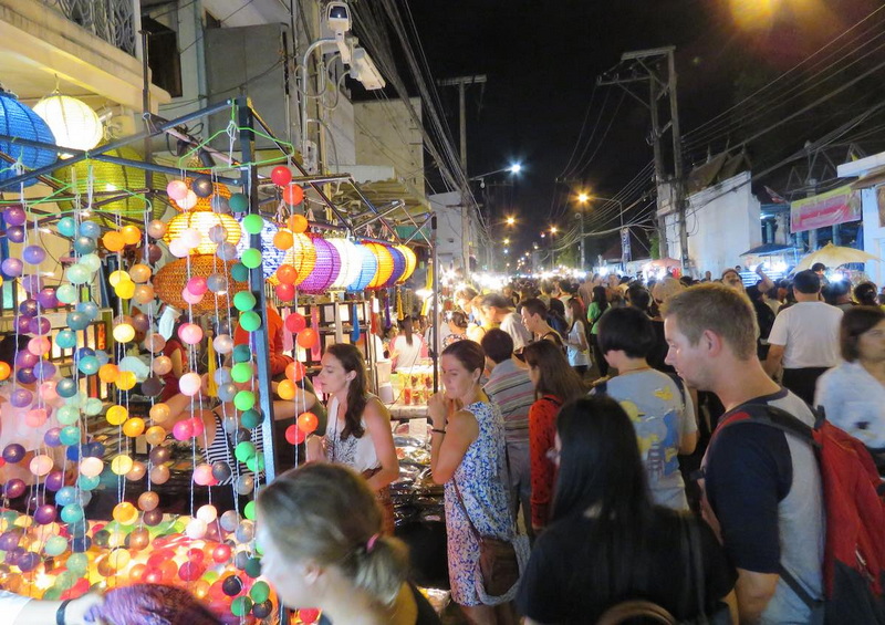 Vibrant Night Market Scene at Sun Day Walking Street Chiang Mai Crowded night market with colorful lanterns and many visitors shopping at Sun Day Walking Street Chiang Mai.