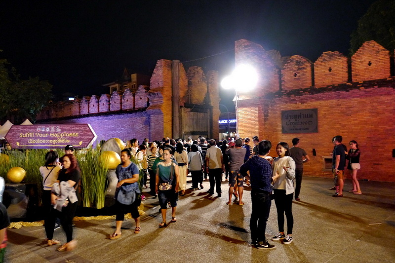 Night Entrance Scene at Best Night Markets In Chiang Mai Crowd walking through a brightly lit brick entrance at night at Best Night Markets In Chiang Mai.