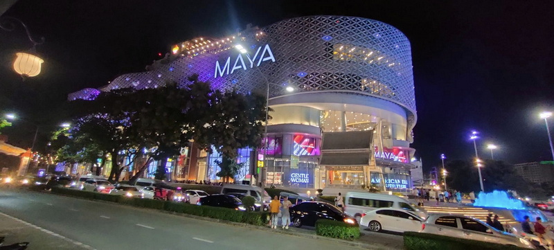 Night Scene of a Modern Building at Nimmanhaemin road Night view of a brightly lit modern building with cars and pedestrians outside at Nimmanhaemin road.