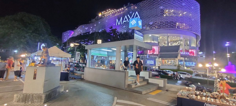 Night Market and Mall Scene at Shopping In Chiang Mai Night scene of a brightly lit shopping mall with markets and people outside at Shopping In Chiang Mai.