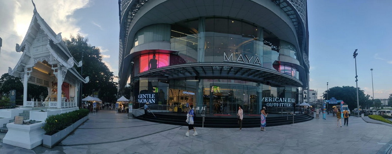 Urban Architecture Scene at Nimmanhaemin road Modern building with colorful LED screens next to a traditional white pavilion at Nimmanhaemin road.