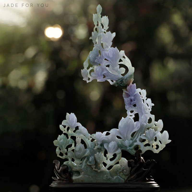 Elaborate white jade sculpture with carved floral designs and flowing curves at Chiang Mai Jade Factory.