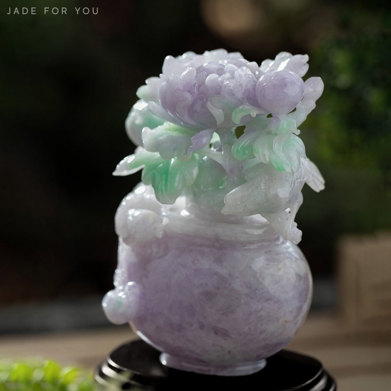 Close-up of a pale jade flower sculpture with carvings and a smooth finish at Orchid Jade Factory.