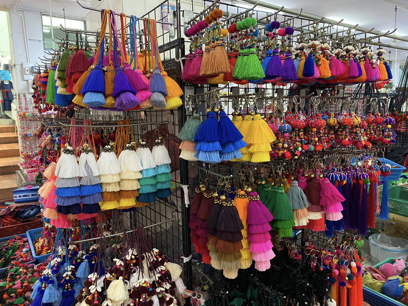 Vibrant tassel earrings and accessories displayed in a market stall at Best Markets In Chiang Mai.