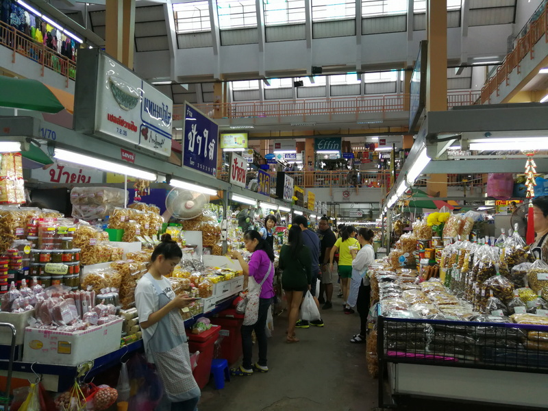 Indoor Market Scene at Best Street Food Markets In Chiang Mai Indoor market with vendors and shoppers browsing food stalls at Best Street Food Markets In Chiang Mai.