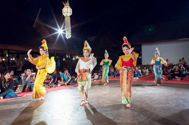 Traditional Thai Dance Performance at Old Chiangmai Cultural Center Khantoke Thai dancers in colorful costumes performing traditional dance at night at Old Chiangmai Cultural Center Khantoke.