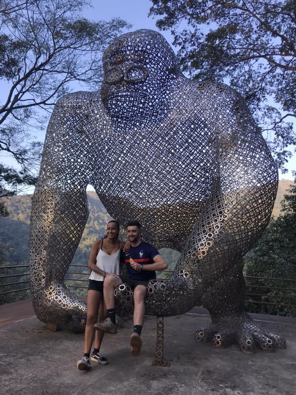 Gorilla Sculpture Encounter at Kingkong Smile Zipline Two people pose next to a large metal gorilla sculpture made of interconnected rings outdoors at Kingkong Smile Zipline.