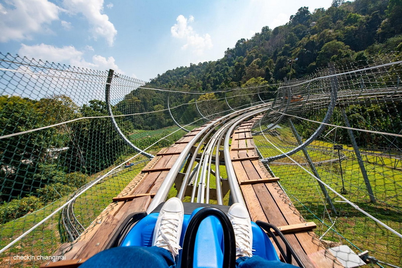 Exciting Zipline Adventure at Pong Yang Zipline View from a zipline showing a person on track with greenery and blue sky at Pong Yang Zipline.