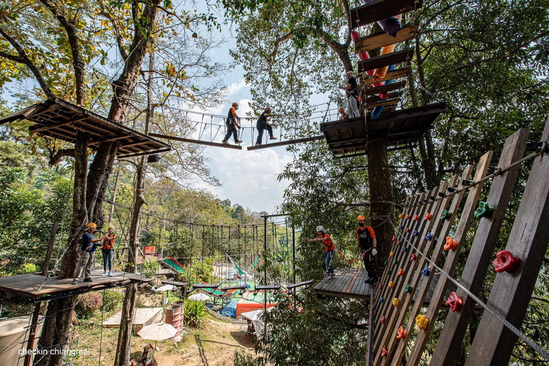 Zipline Forest Adventure at Pong Yang Zipline and Jungle Coaster People crossing rope bridges among trees at a zipline adventure park in a forest setting at Pong Yang Zipline and Jungle Coaster.