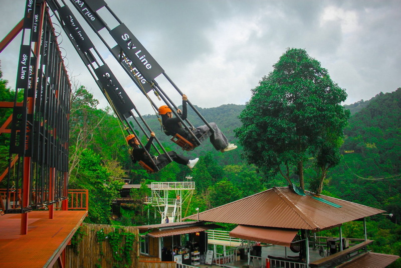 Skyline Jungle Luge Swing Ride People swinging on sky line swings with green hills in the background at Skyline Jungle Luge.