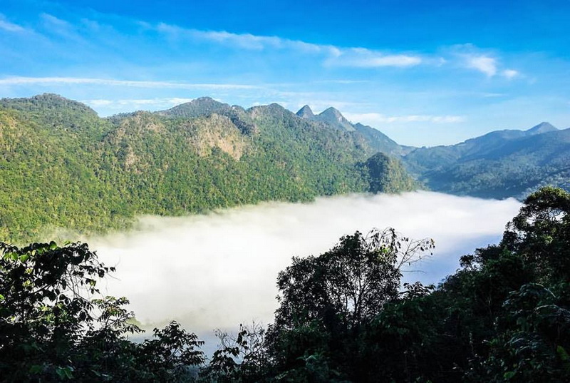 Mountain View with Fog at Doi Ang Khang Wide mountain landscape with fog-filled valley and blue sky above at Doi Ang Khang.
