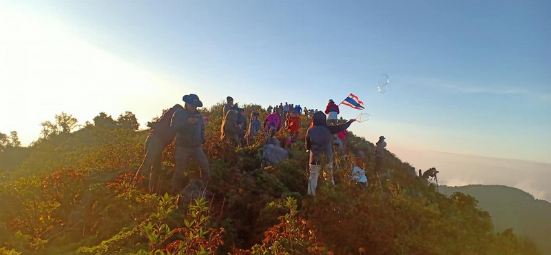 Gathering at Mountain Peak at Doi Luang Chiang Dao People celebrating on a mountain summit with kites and scenic views at Doi Luang Chiang Dao.