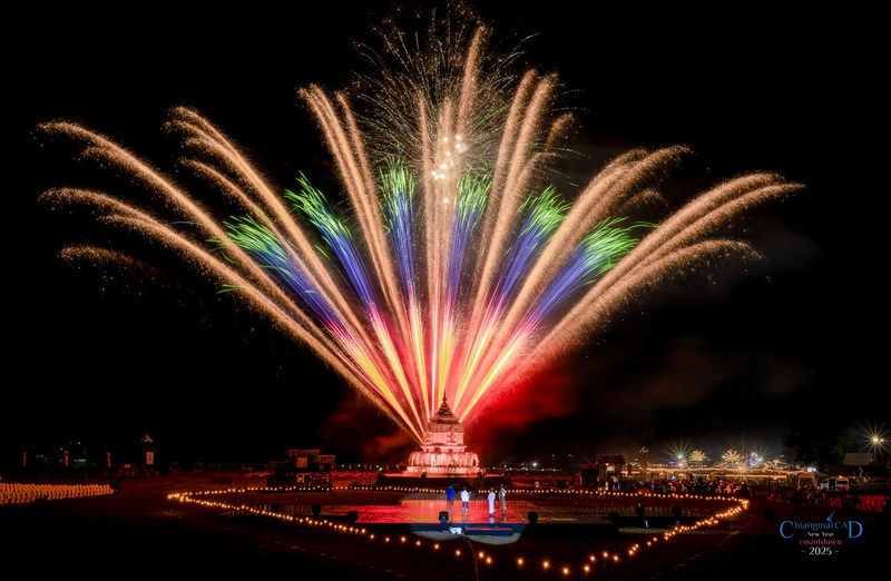 Fireworks explode above a temple during a night celebration at New Year Countdown Chiang Mai by CAD.