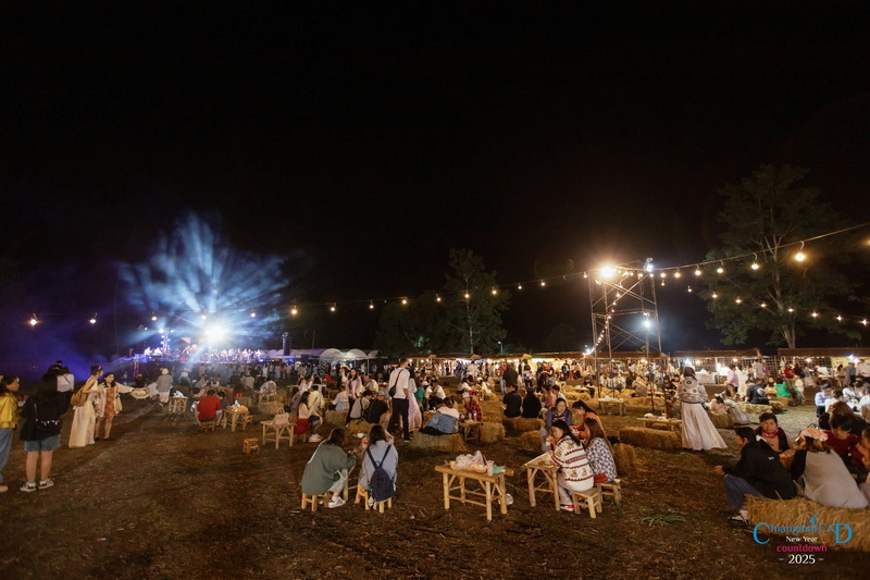 Crowd enjoying fireworks and outdoor event at night with stage and string lights at Chiang Mai New Year Countdown 2027 by CAD.
