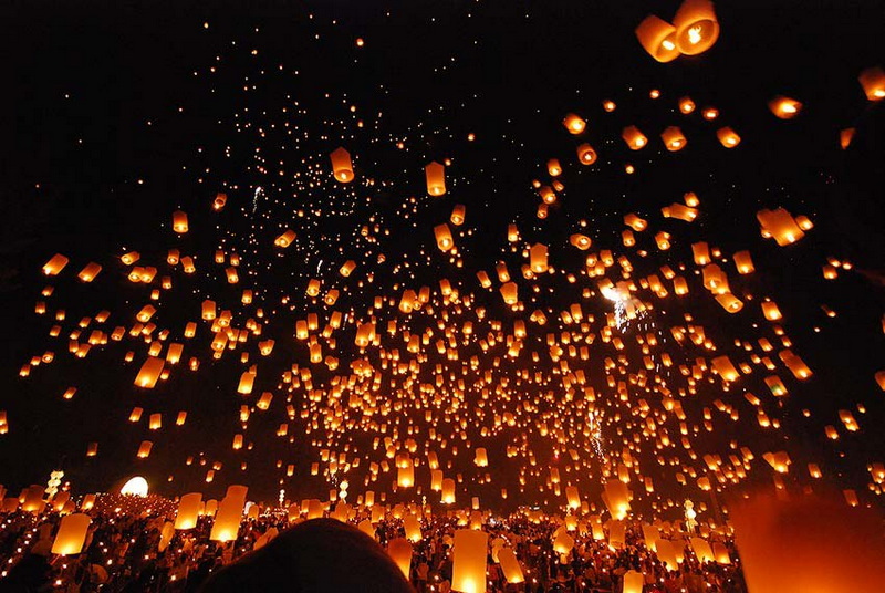 Sky filled with glowing lanterns released during a festival at night at Yi Peng Chiang Mai.