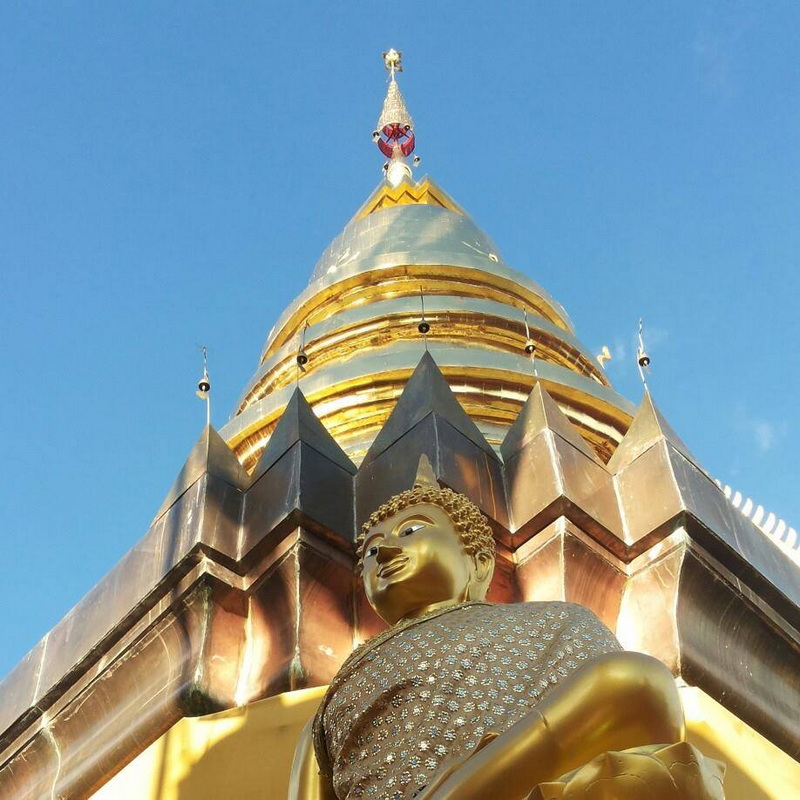 Golden Stupa in Clear Sky at Kruba Sri Wichai Monument Golden stupa with detailed spire against a clear blue sky at Kruba Sri Wichai Monument.
