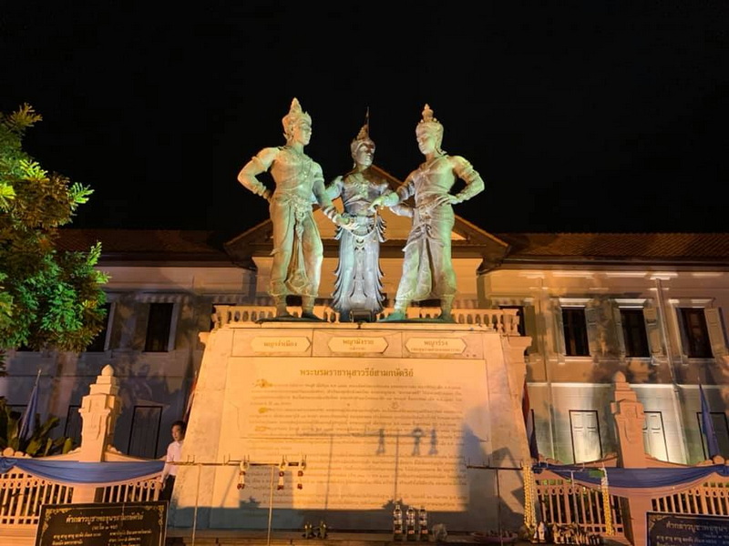 Nighttime Monument with Statues at Three King Monument Night view of a monument with three bronze statues illuminated at night, trees on the side at Three King Monument.