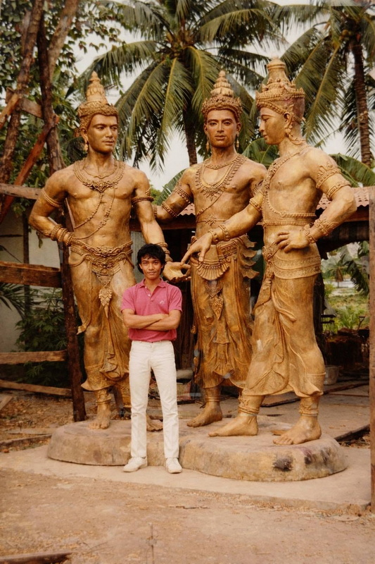 Boy with Wooden Sculptures at Three kings Monument Young boy standing with large wooden carved statues of historical figures under palm trees at Three kings Monument.