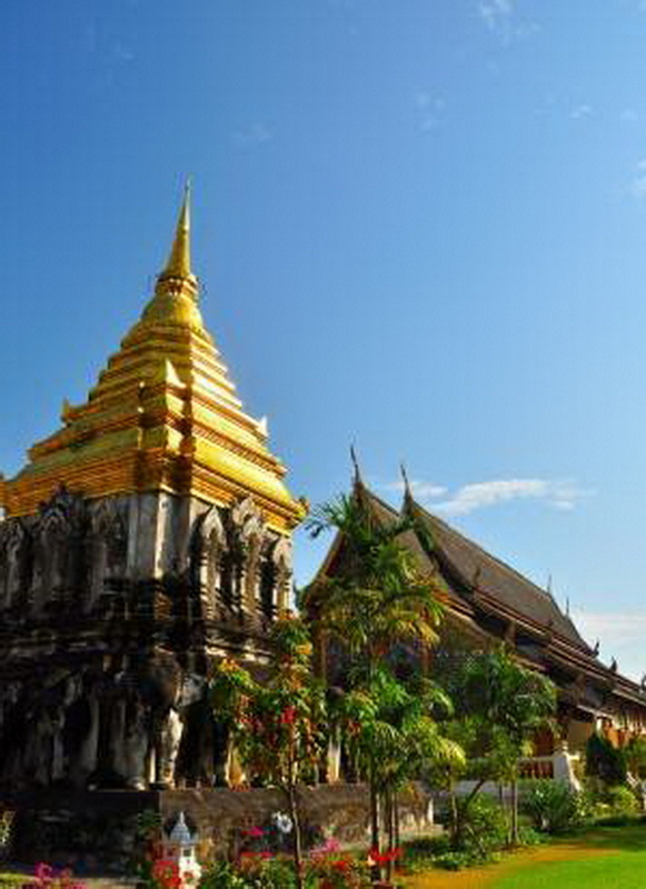 Golden Pagoda and Temple at Wat Chiang Man Golden pagoda and traditional temple with lush greenery nearby at Wat Chiang Man.