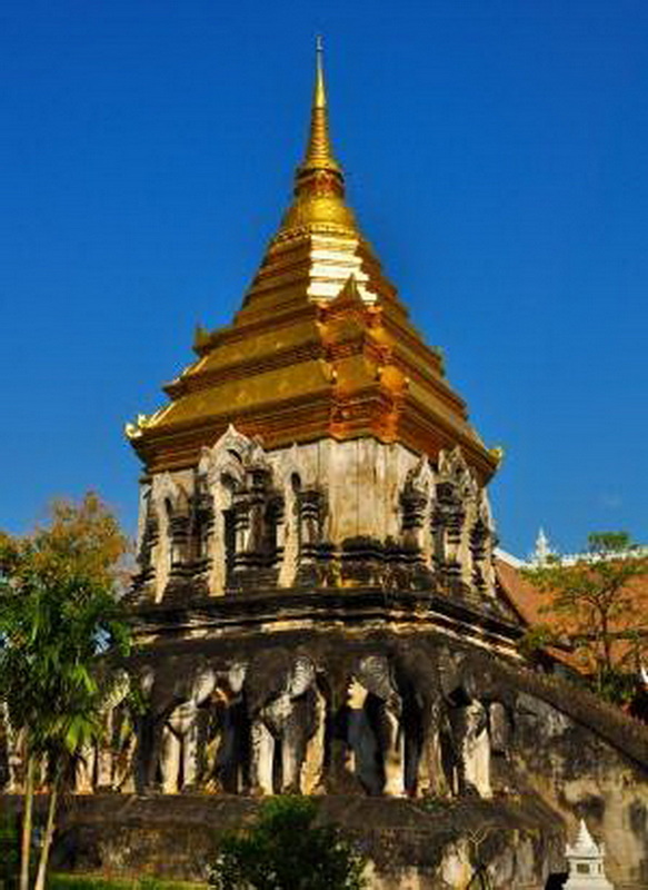 Golden Pagoda with Elephant Support at Wat Chiang Man Golden pagoda with elephant sculptures at its base and a clear blue sky behind at Wat Chiang Man.