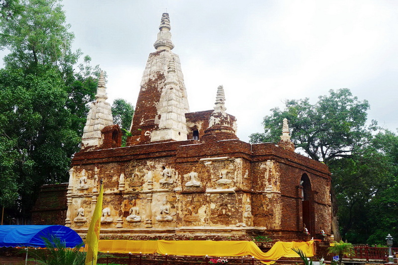 Historic Brick Temple at Wat Jed Yod Ancient brick temple with spires and detailed carvings surrounded by trees at Wat Jed Yod.