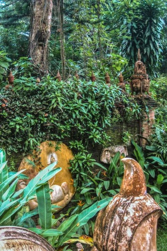 Lush Garden with Statues at Wat Pha Lad Decorative statues integrated into a green garden wall covered with plants at Wat Pha Lad.