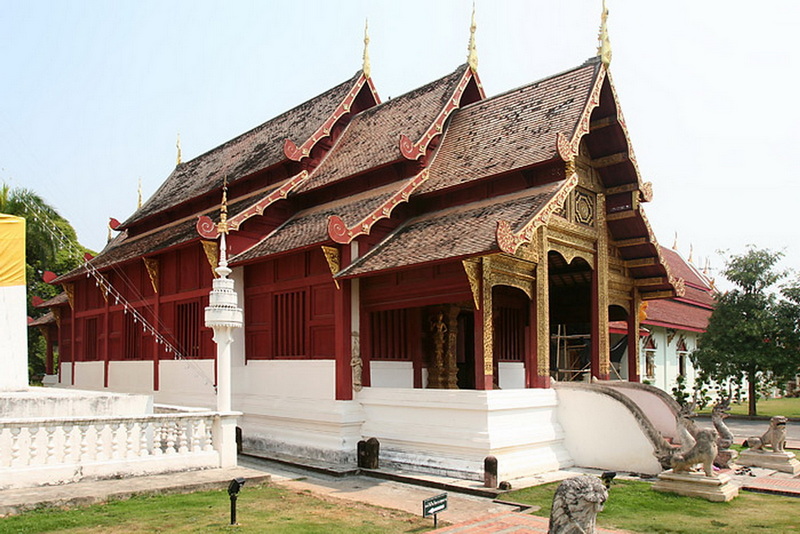 Thai Temple Architecture Scene at Wat Phra Singh Traditional Thai temple with detailed roof and vibrant colors at Wat Phra Singh.